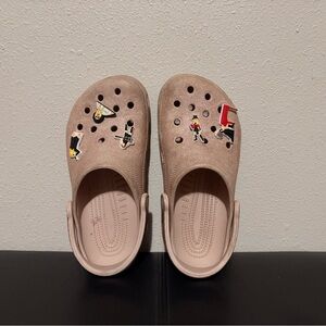 Woman’s pink sparkly crocs with Taylor swift charms